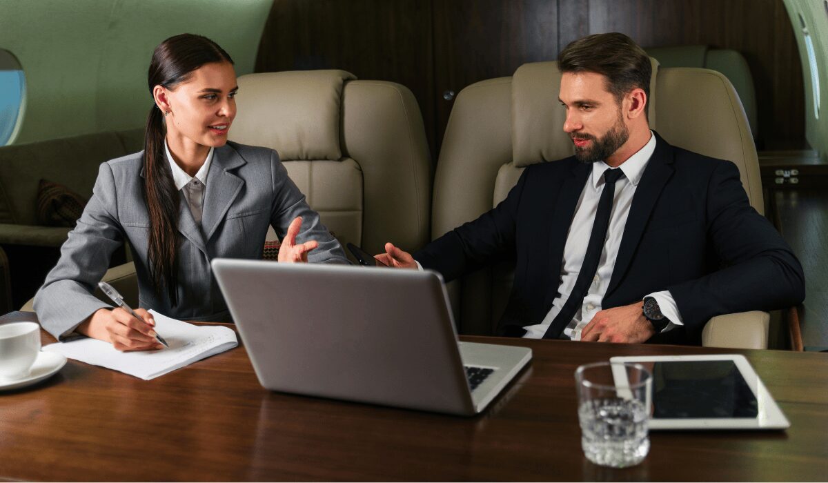 private jets for business travel - two business people working on a plane