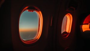 Dark aeroplane cabin showing tinted windows.